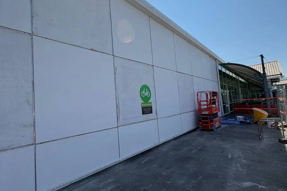 Long external elevation of an Asda store in Bristol finished in smooth white render